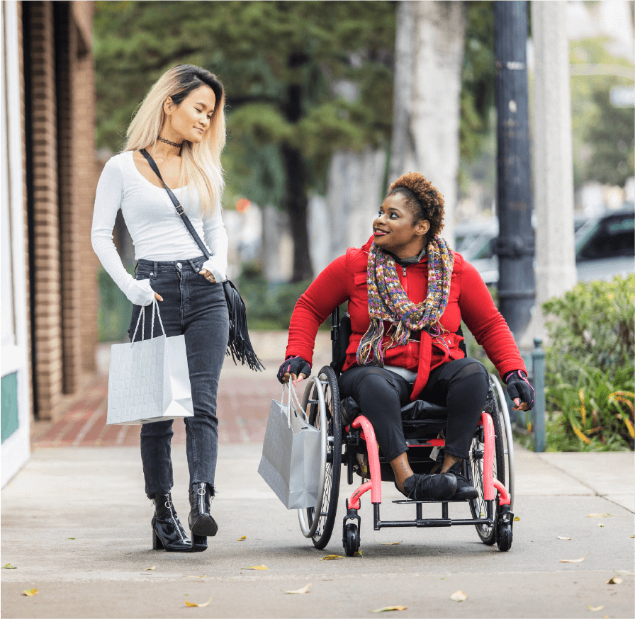 Two woman outside, carryng shopping bags